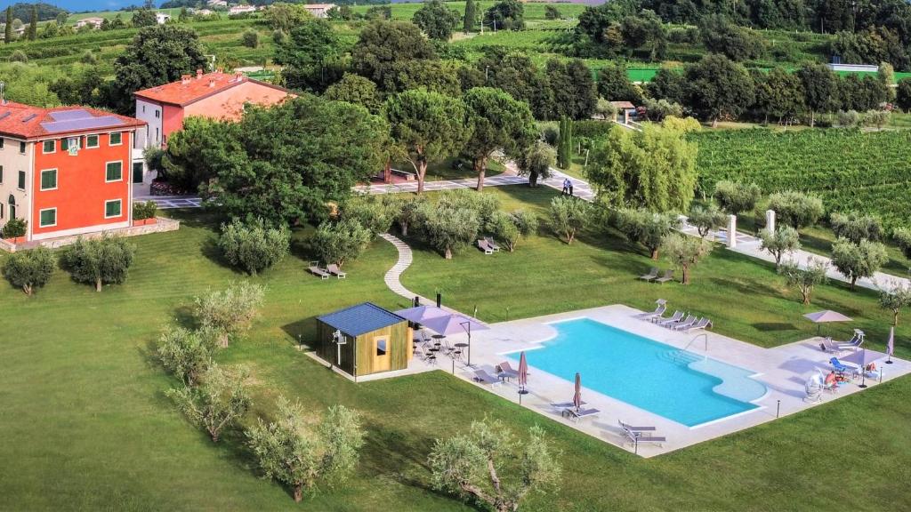 an aerial view of a house and a swimming pool at Borgo Romantico Relais in Cavaion Veronese