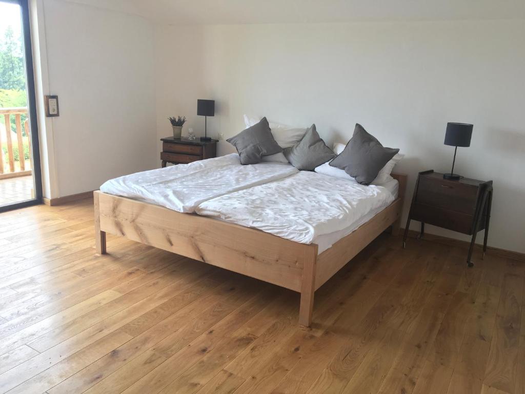 a bedroom with a bed with white sheets and pillows at Haus Tersteegen in Oberbrombach