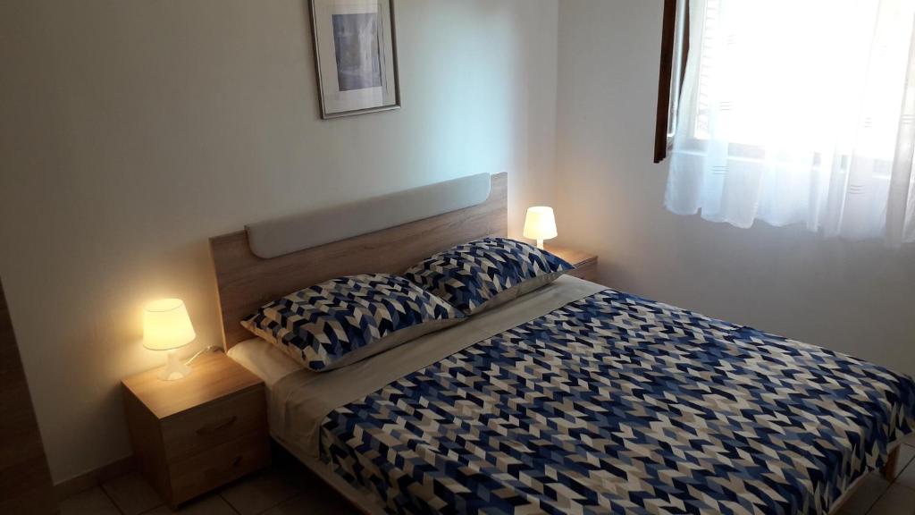 Llit o llits en una habitació de Apartmani Mia