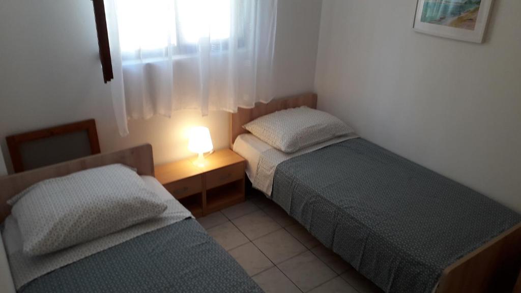 Llit o llits en una habitació de Apartmani Mia