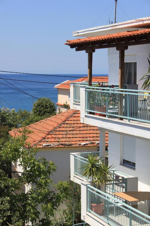 a building with balconies and the ocean in the background at House Fedra in Potos