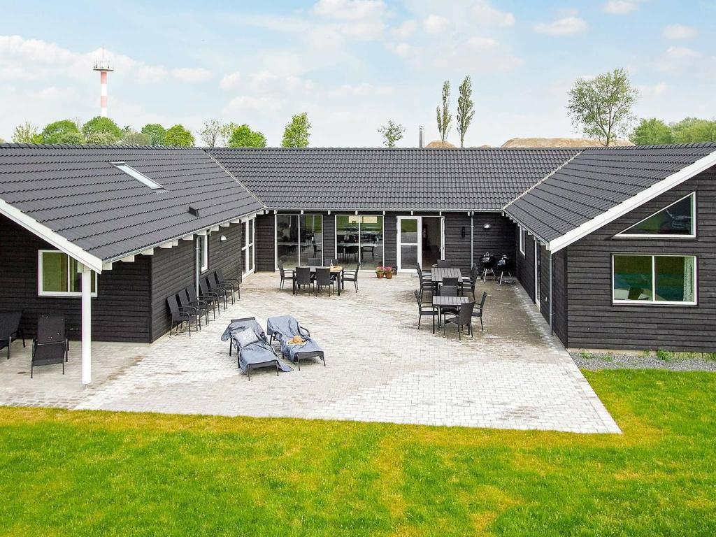 a black building with chairs and a patio at Holiday home Kappeln XI in Kappeln