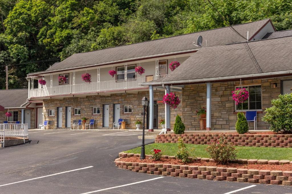 a building with flowers on the balconies of it at Budget Inn Watkins Glen in Watkins Glen