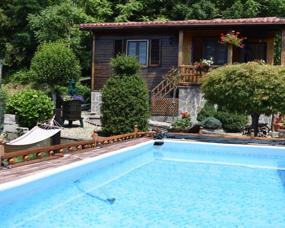 a swimming pool in front of a house at Baita La Stradella in Serravalle