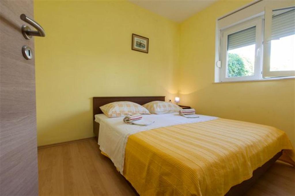 Postel nebo postele na pokoji v ubytování Apartments Marino Gojak
