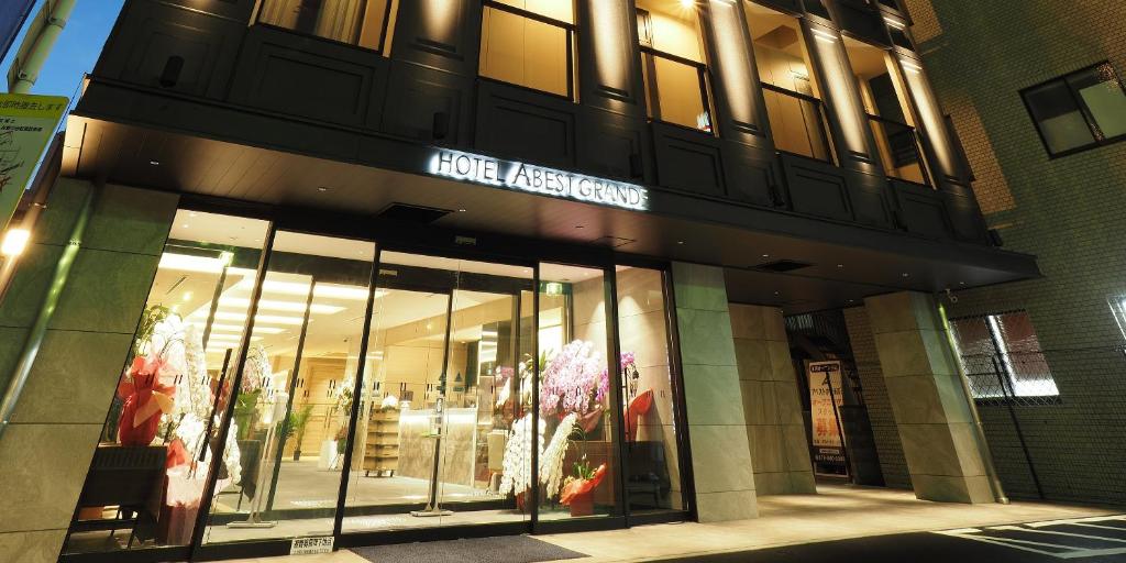 a store front of a building with a sign on it at Hotel Abest Grande Takatsuki in Takatsuki