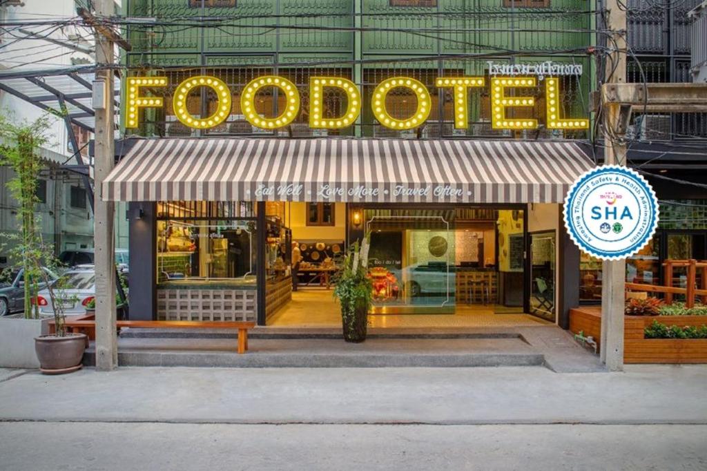 a food store with a sign on the front of it at FOODOTEL in Bangkok