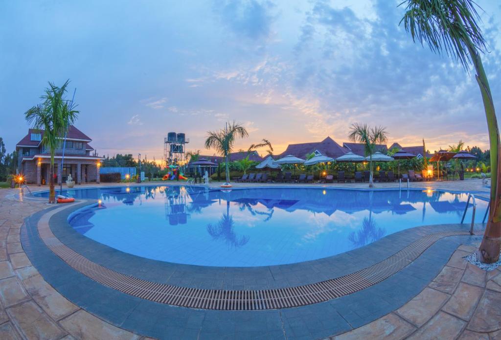a large swimming pool at a resort at dusk at Ciala Resort Hotels In Kisumu in Kisumu
