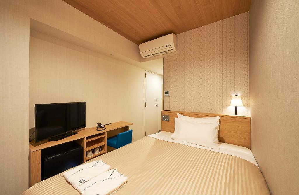 Postel nebo postele na pokoji v ubytování Sotetsu Fresa Inn Tokyo Tamachi