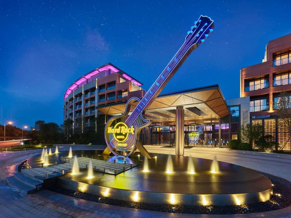 un hotel con una estatua de guitarra frente a un edificio en Hard Rock Hotel Dalian, en Dalian