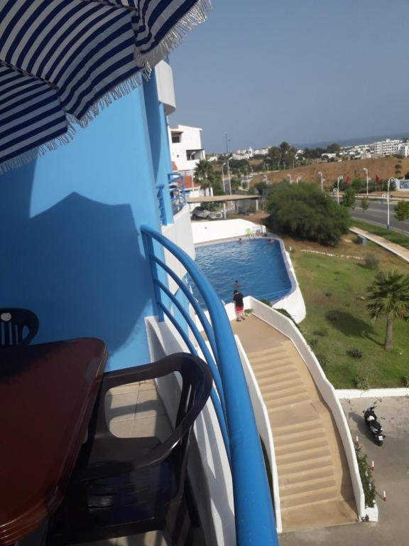 a balcony with a slide and a swimming pool at Studio avec piscine Cabo Dream à Cabo négro in Cabo Negro