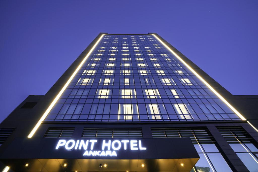 a large building with a clock on the front of it at Point Hotel Ankara in Ankara