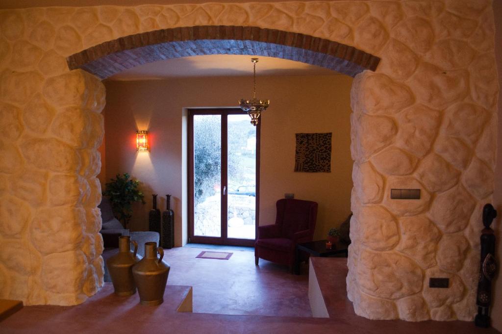 a living room with a stone wall and a doorway at Quinta Serra De Sao Mamede in Castelo de Vide