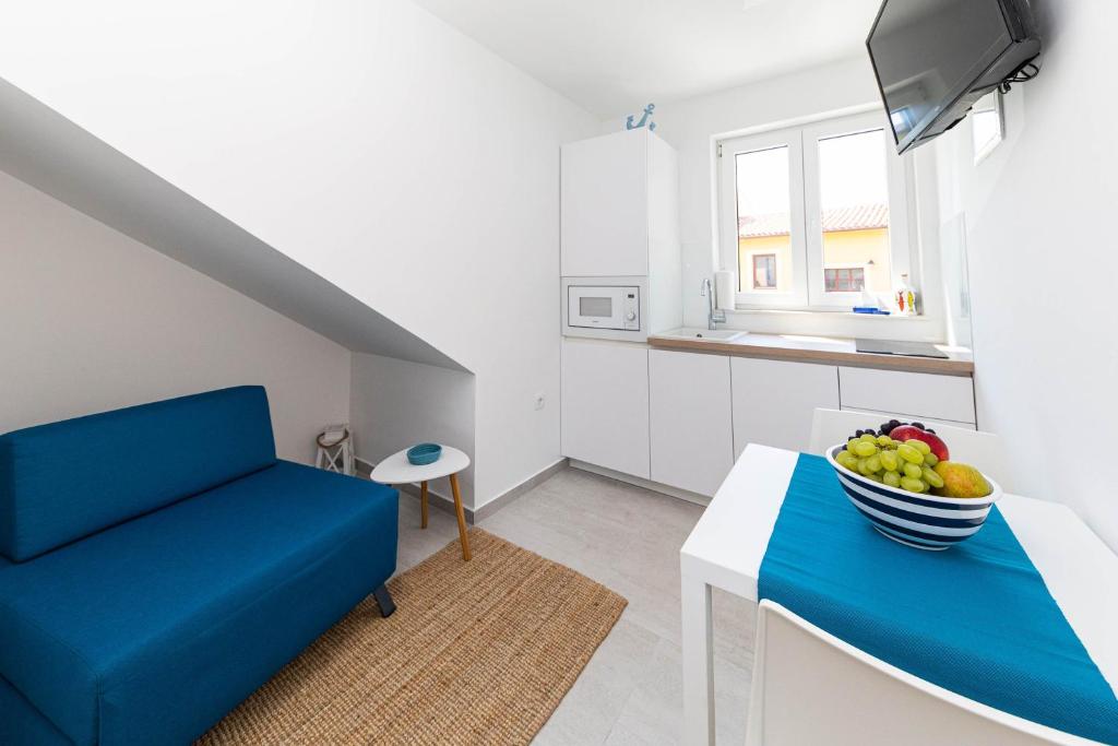 Televízia a/alebo spoločenská miestnosť v ubytovaní APARTMANI VIGO