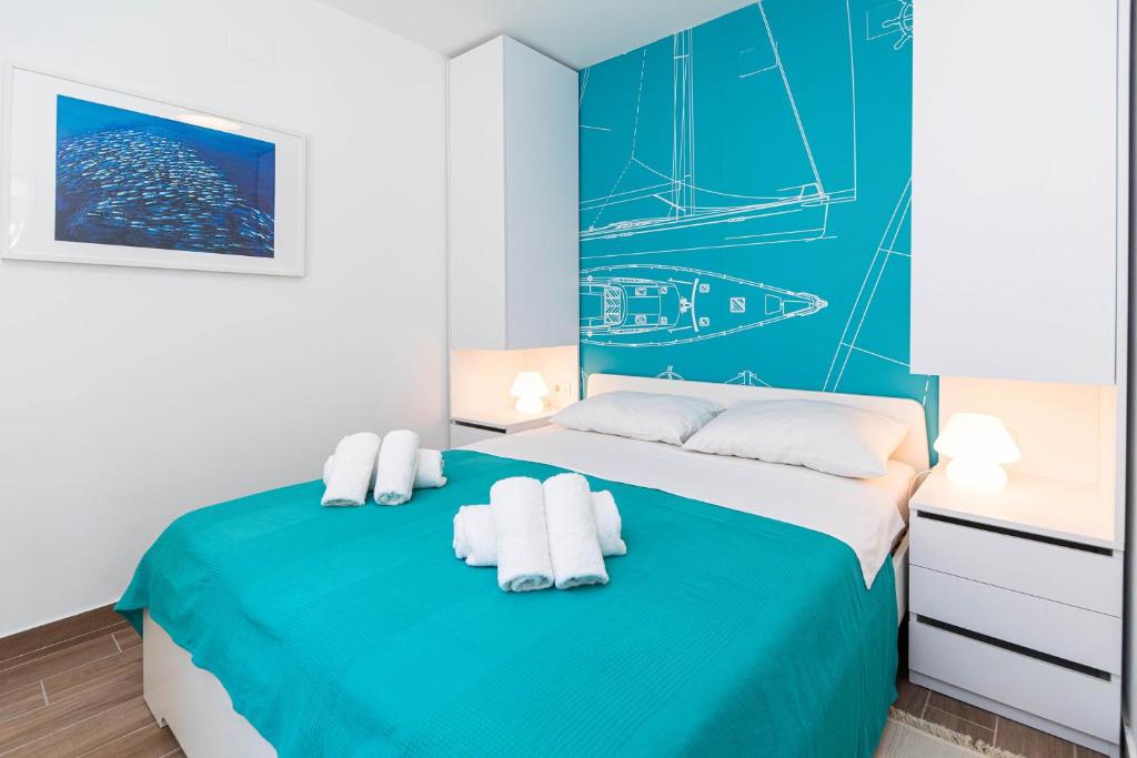 Posteľ alebo postele v izbe v ubytovaní APARTMANI VIGO