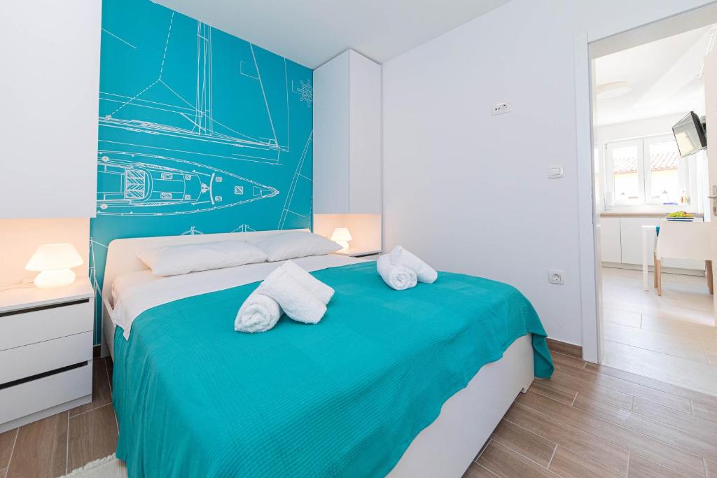 Posteľ alebo postele v izbe v ubytovaní APARTMANI VIGO