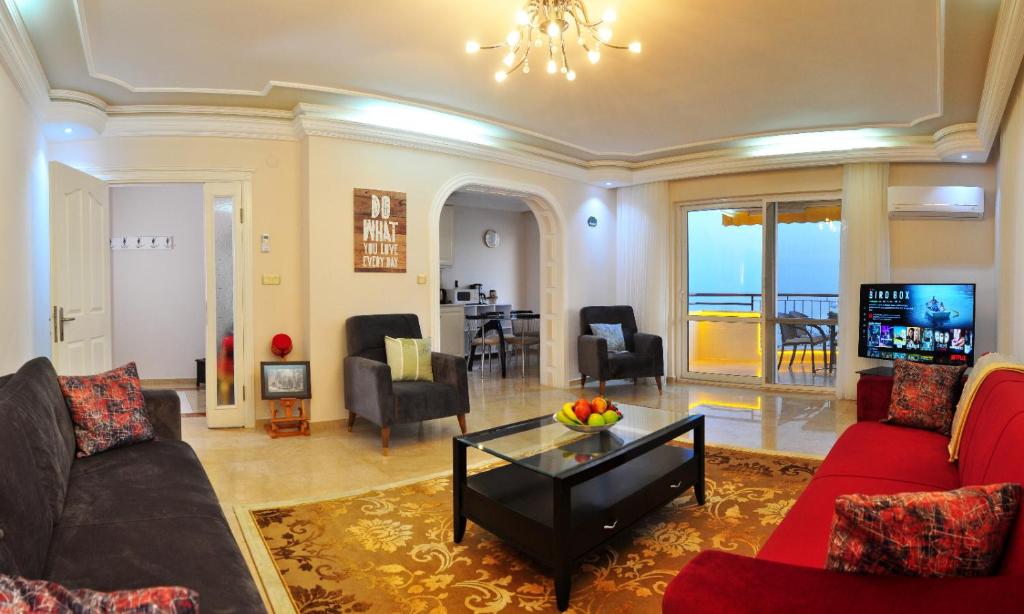 a living room with a couch and a table at Cebeci Apartments - Extrahome in Mahmutlar