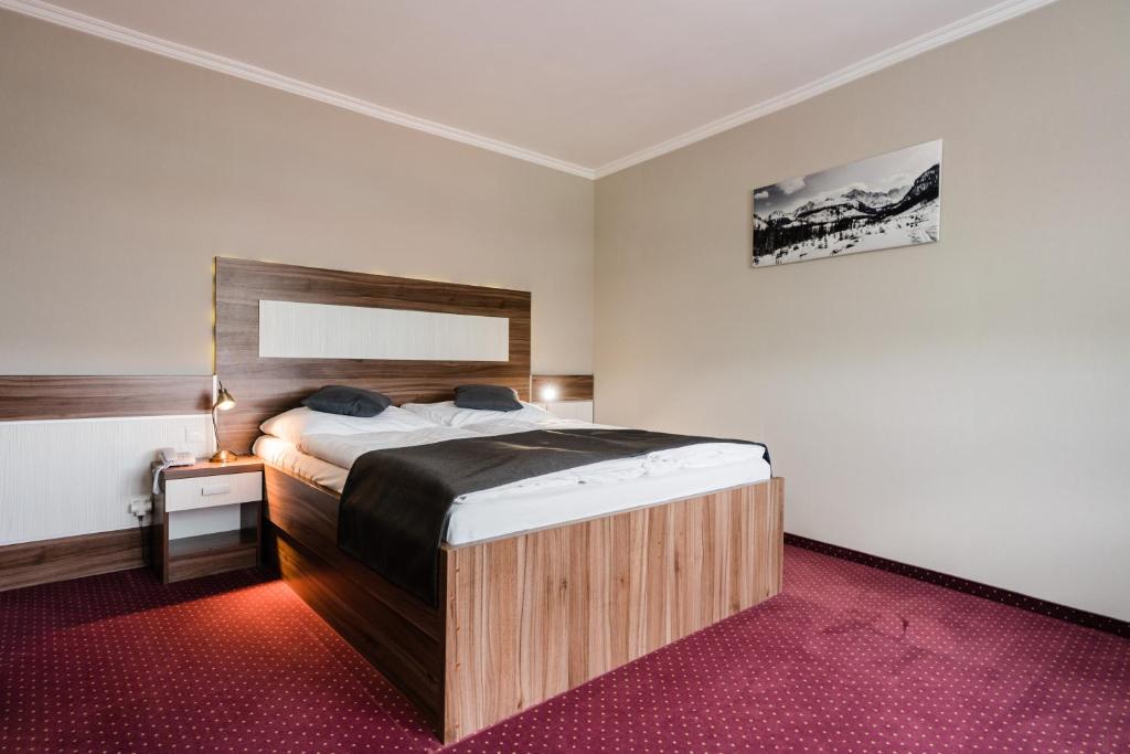 Postel nebo postele na pokoji v ubytování Hotel Menhard
