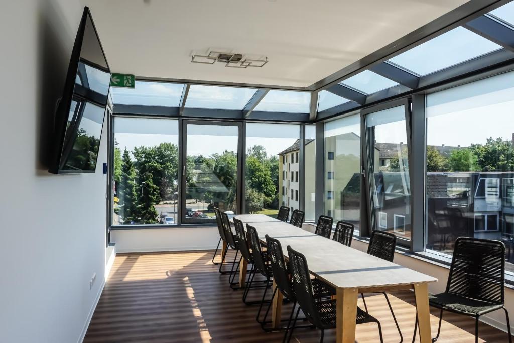 a conference room with a long table and chairs at nicetostay in Bremen