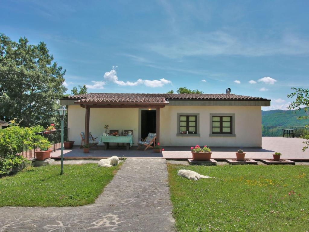 a small house with animals laying in the yard at Farmhouse in Apecchio with Swimming Pool Terrace Garden BBQ in Apecchio