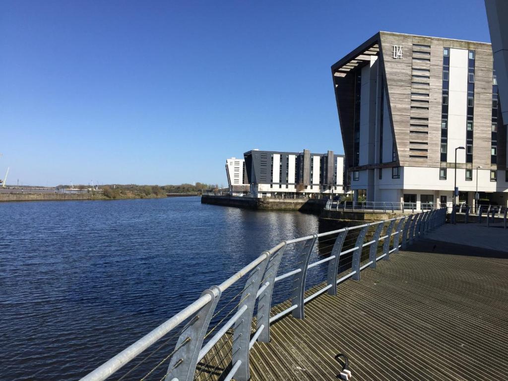 a building on a pier next to a body of water at Home from home with fantastic views in Runcorn