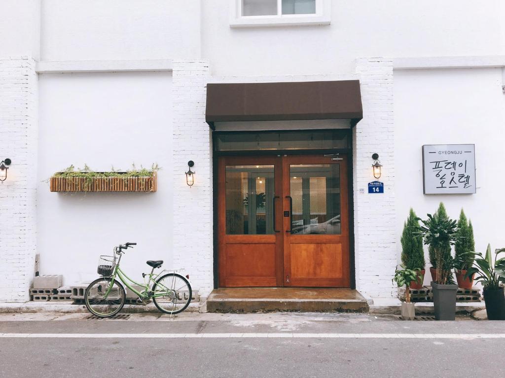 a bike parked in front of a building with a door at Minihotel Poongdaengi in Gyeongju
