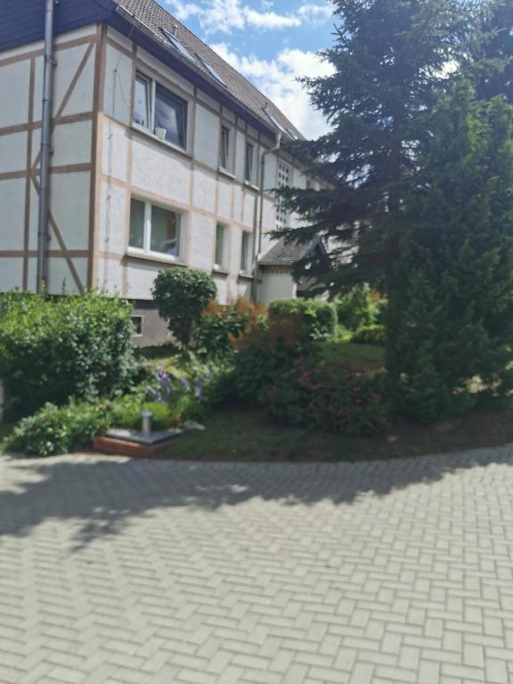 a brick driveway in front of a building at Pension Harzbaude Susanne - Garni in Rübeland