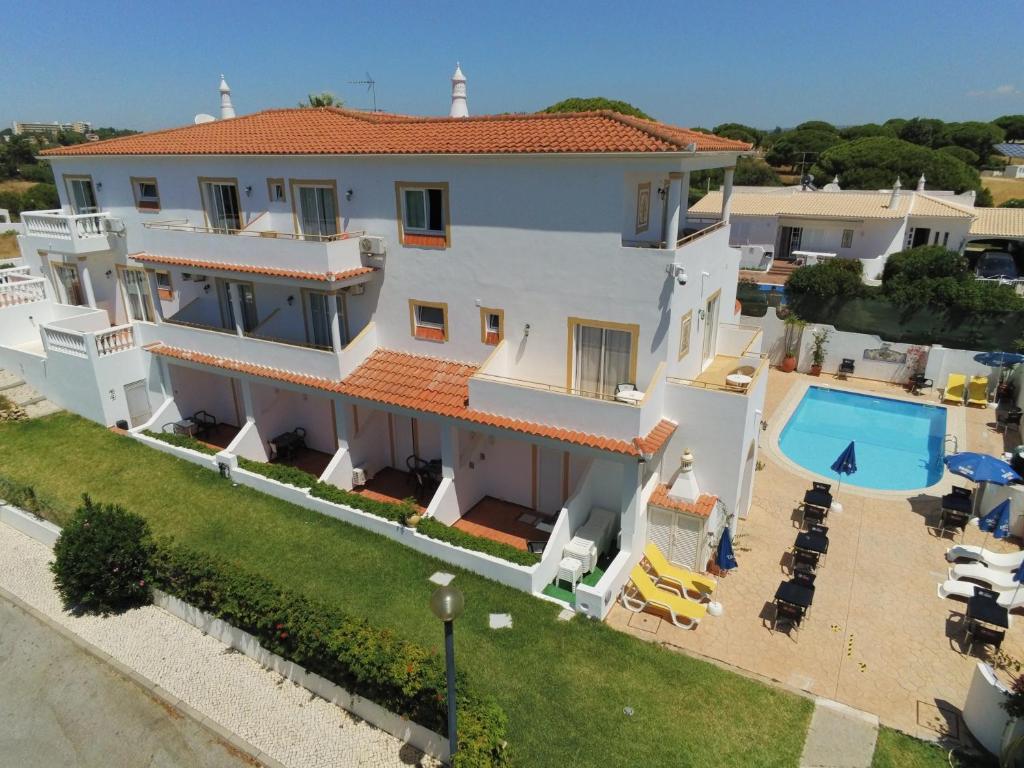 an aerial view of a house with a swimming pool at Agua Marinha ROSA- Hotel in Albufeira