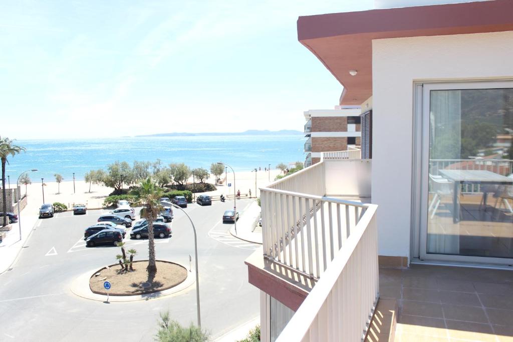 a balcony of a building with a view of a street at Beautiful loft, huge sunny terrace, view over the beach and sea in Roses