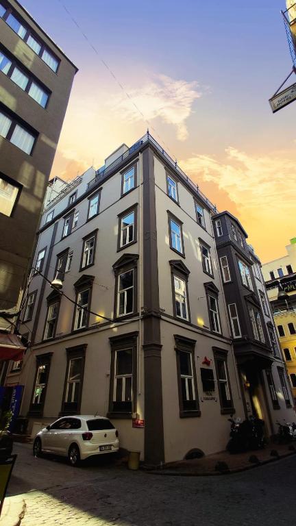 a large building with a car parked in front of it at The Independent Hotel Taksim in Istanbul