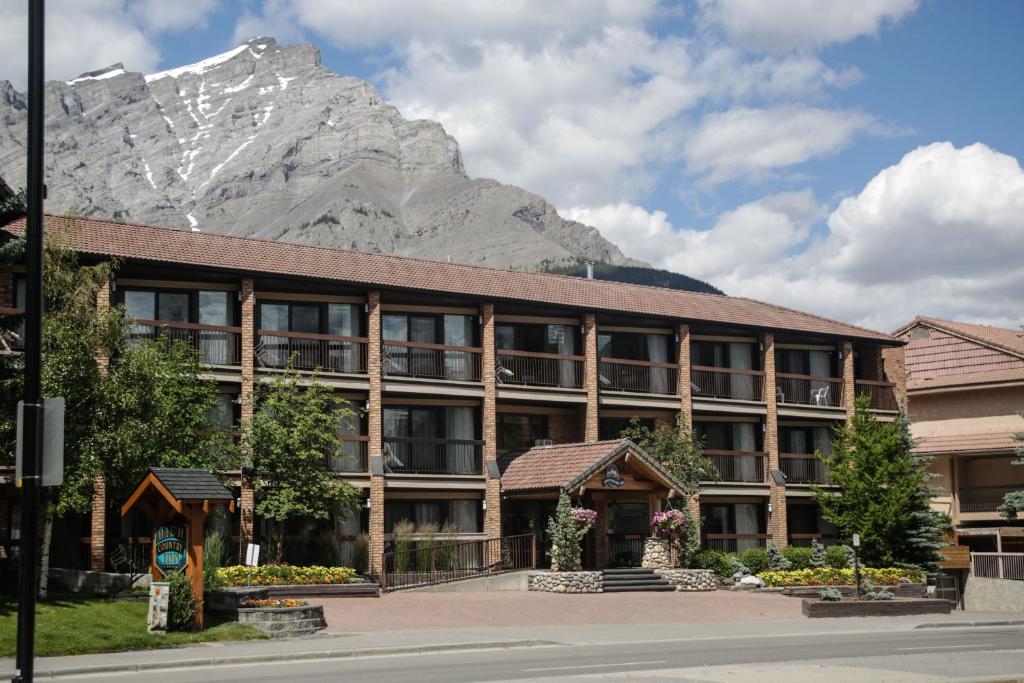 a large building with a clock on top of it at High Country Inn in Banff