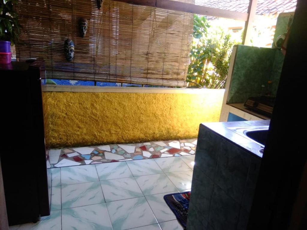 a bathroom with a sink and a tile floor at Pondok Pusaka Alam 2 Pangandaran in Pangandaran