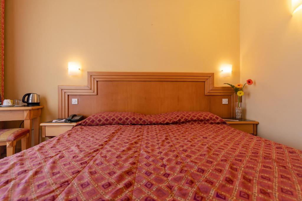 En eller flere senge i et værelse på Hotel San Andrea