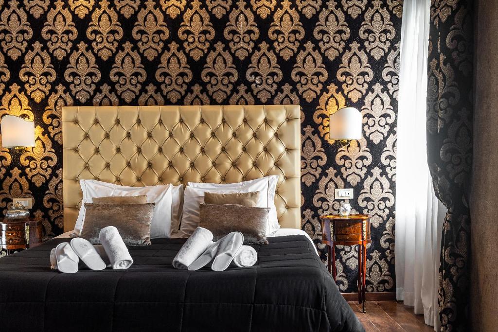 a bedroom with a bed with white shoes on it at Domus Superior in Venice