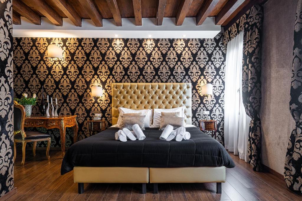 a bedroom with a bed with white shoes on it at Domus Superior in Venice