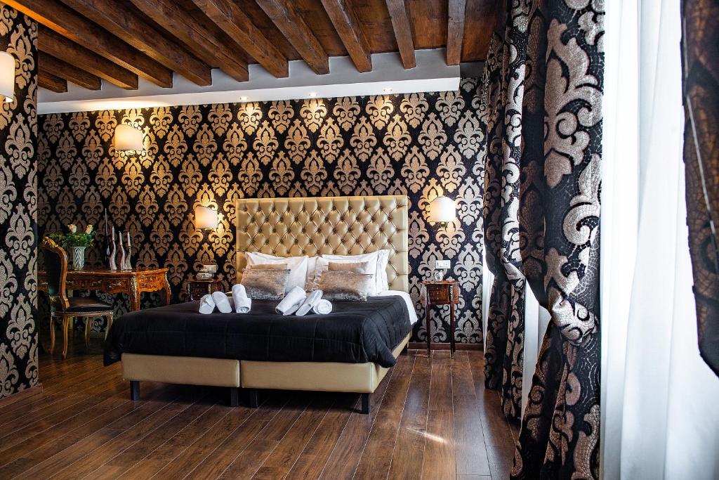 a bedroom with a bed with white shoes on it at Domus Superior in Venice