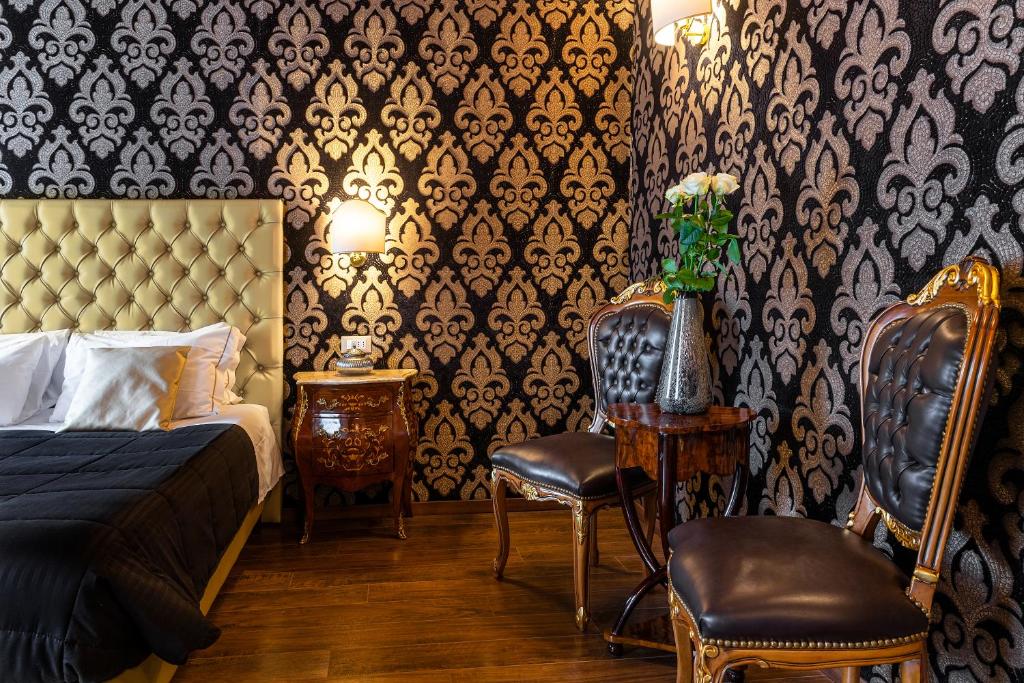 a bedroom with a bed and two chairs at Domus Superior in Venice