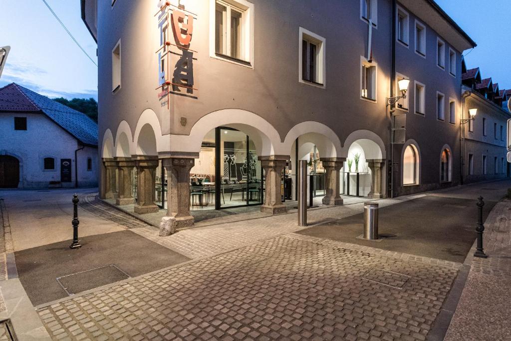 a large building with arches on a street at Hostel Situla in Novo Mesto