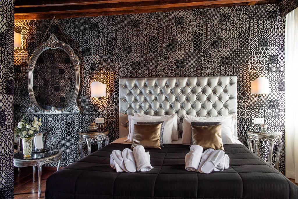 a bedroom with a large bed and a mirror at Domus Superior in Venice