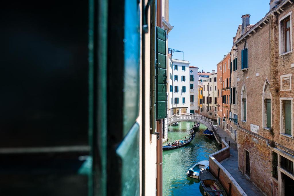 a view from a window of a canal with a bridge at Domus Superior in Venice
