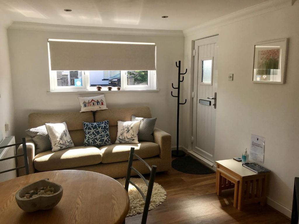 a living room with a couch and a table at Kiki’s Corner in Newquay