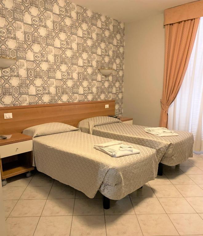 Postel nebo postele na pokoji v ubytování Hotel Lo Scudiero