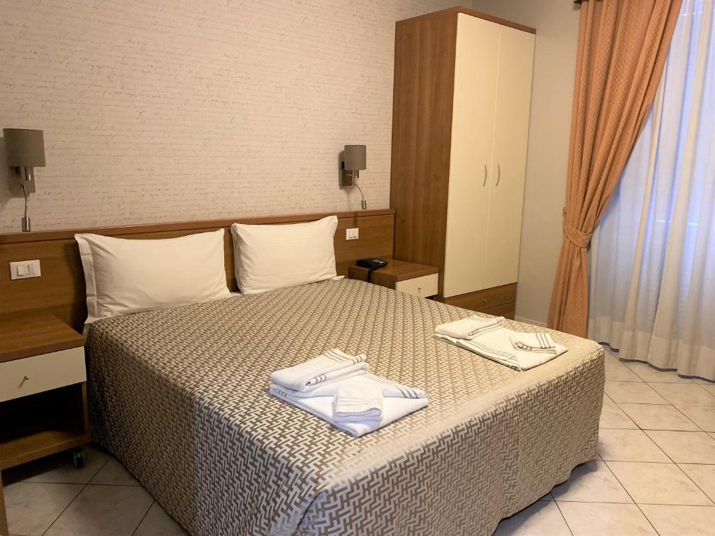 Postel nebo postele na pokoji v ubytování Hotel Lo Scudiero
