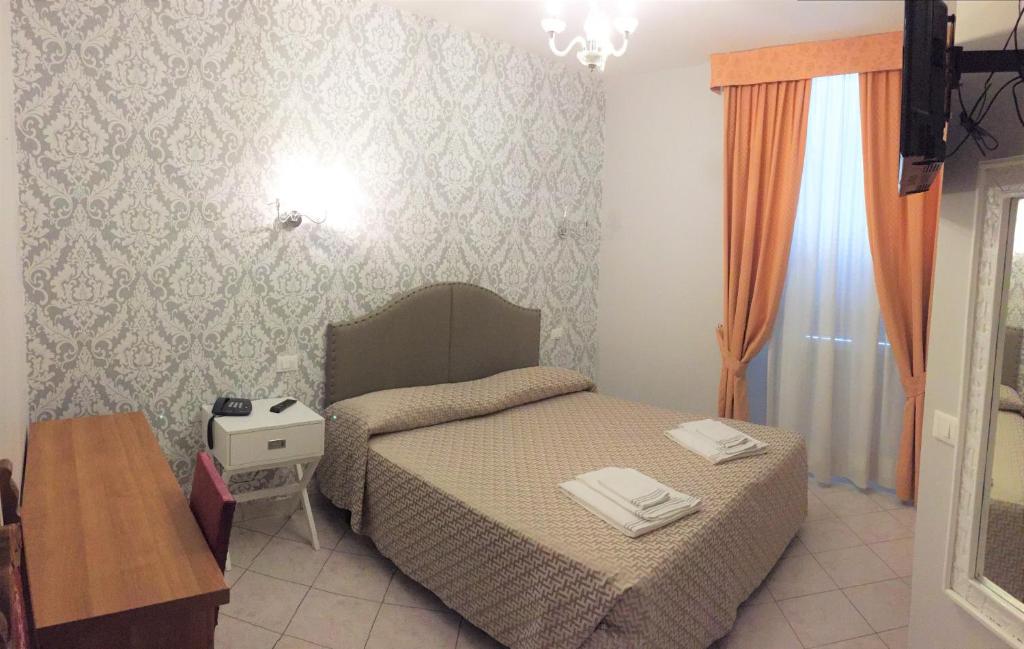 Postel nebo postele na pokoji v ubytování Hotel Lo Scudiero