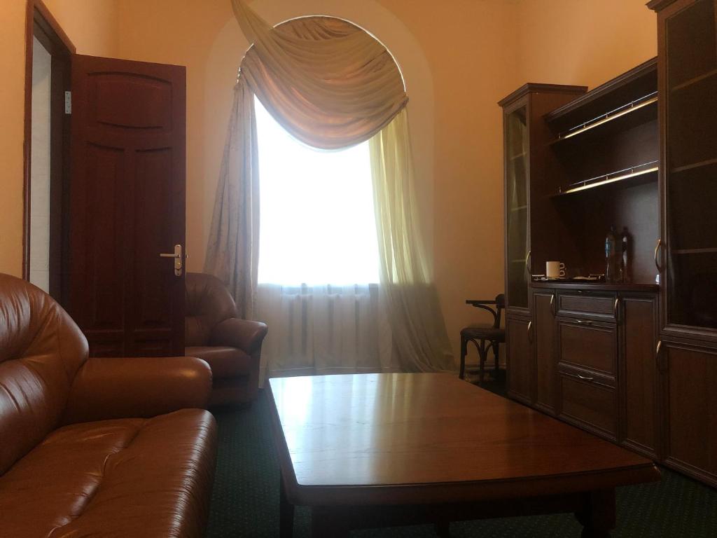 a living room with a couch and a window at Budynok Pyschevycha in Oleksandriya