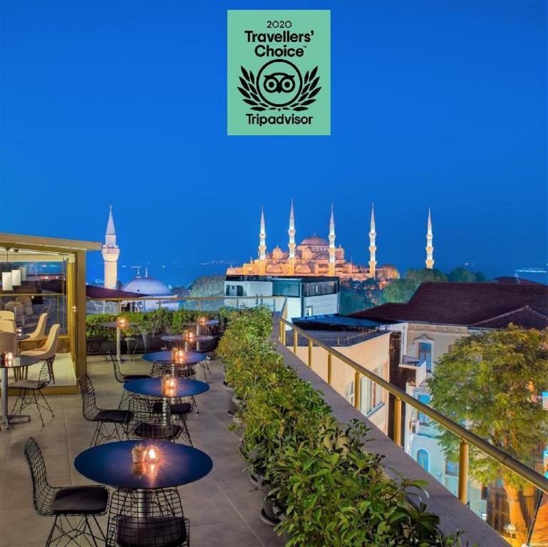 a restaurant with tables, chairs and umbrellas at Tan Hotel - Special Category in Istanbul