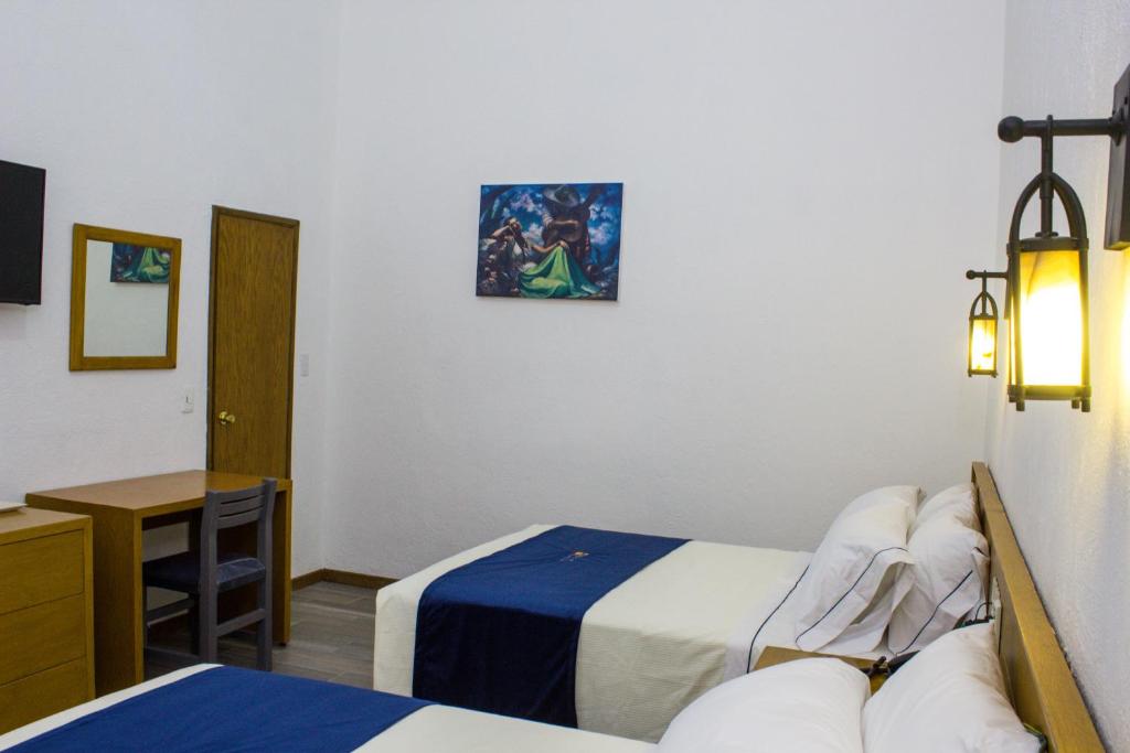Postel nebo postele na pokoji v ubytování Hotel Real de Castilla Colonial