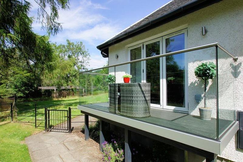 a balcony of a house with a glass roof at Riverbank in Callander