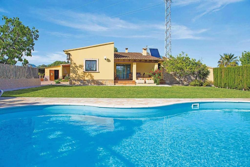 a large swimming pool in front of a house at Villa Vilar by Sealand Villas in El Port
