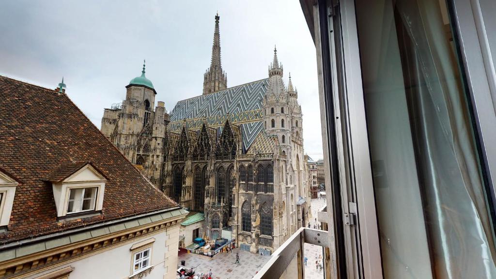a view of a cathedral from a window at Amazing View_Loft Apartment in the heart of Vienna in Vienna